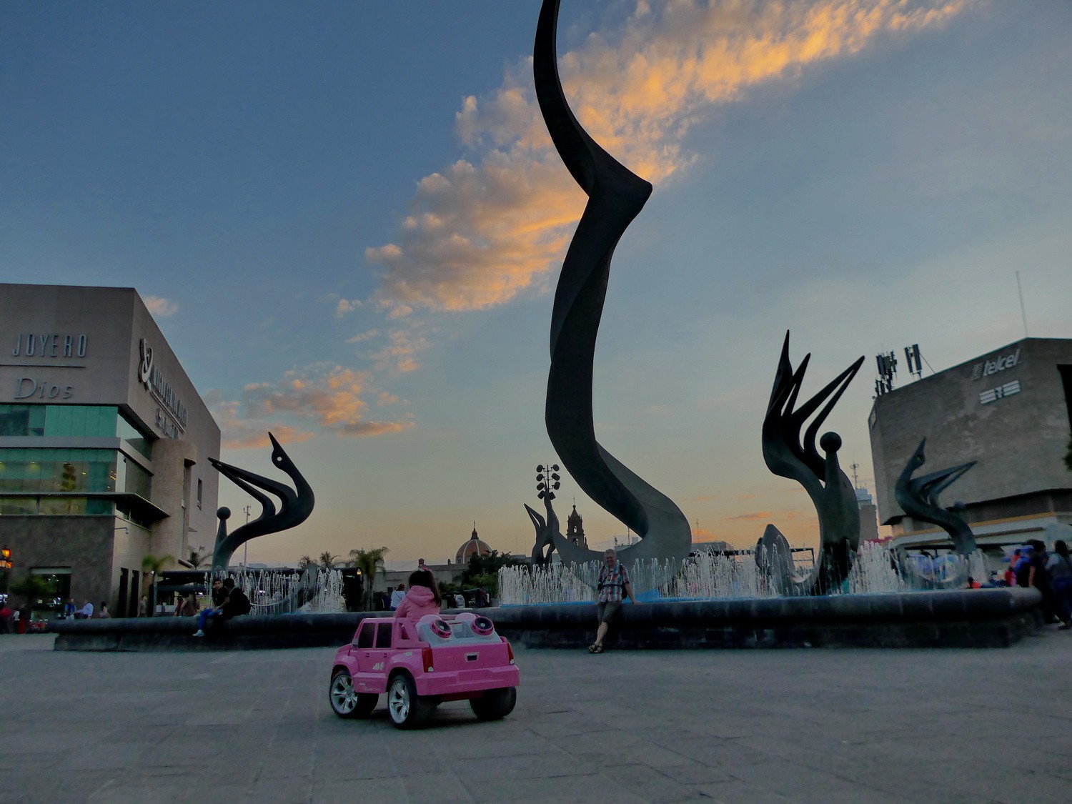 Girl with pink Cadillac at sunset